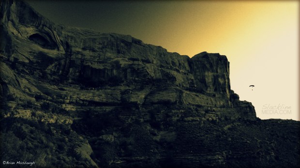 Jamie Crawford soaring under canopy during sunset off of G-Spot in Moab, UT.