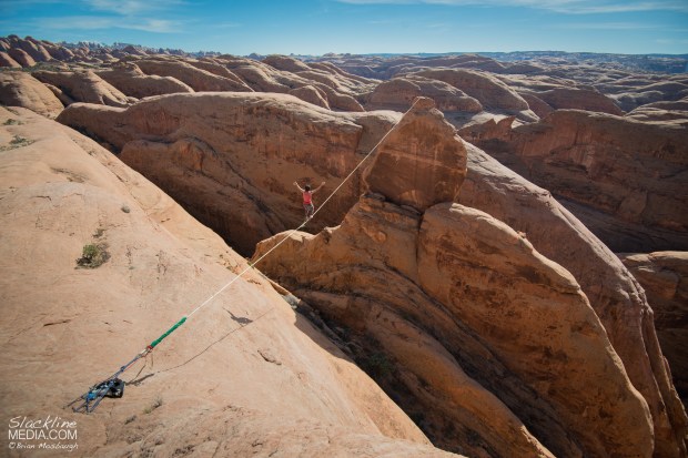 Andy Lewis getting lost in the infinite fin features of Moab on a highline he established last year, Weigh Wyrd (205' long). 